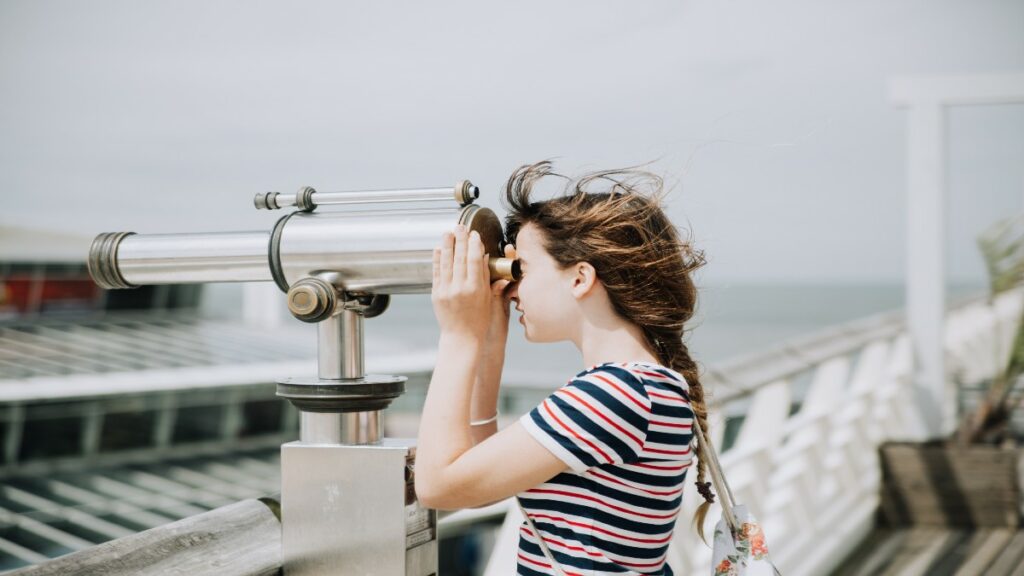 Woman looking through binoculars to achieve API discoverability  